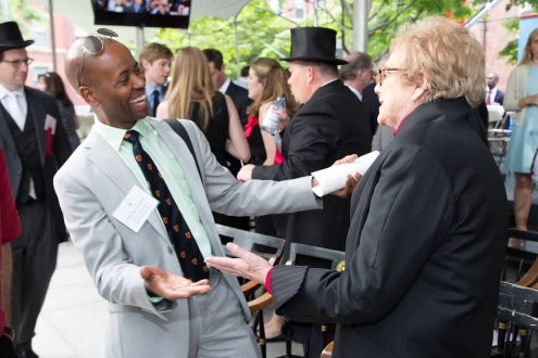 Alumni greet each other.
