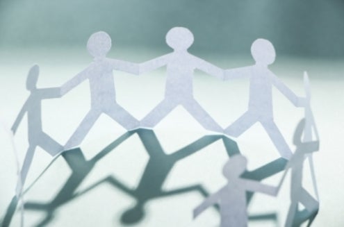 Paper dolls holding hands