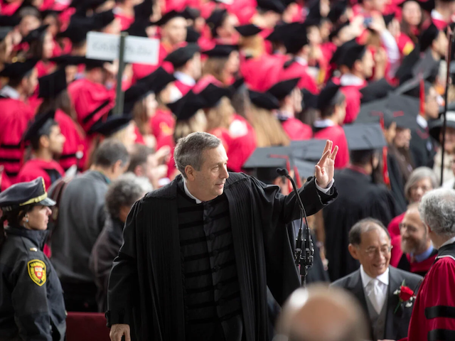 Larry Bacow waves at Harvard Commencement
