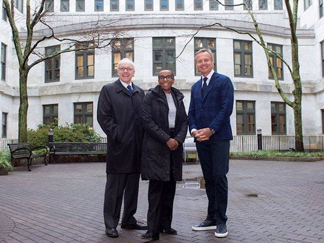 Ernesto Bertarelli (right) joins HMS Dean George Q. Daley (left) and Harvard University President-elect Claudine Gay (center) on the HMS campus in the courtyard of Building C, which will be enclosed to create a new skylighted atrium, thanks to a philanthropic gift from the Bertarelli family