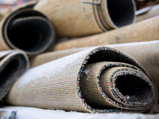 A pile of rolled-up carpets