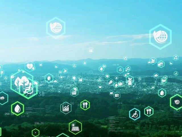An illustration with a variety of symbols in green and blue hexagons set in front of an outdoor vista