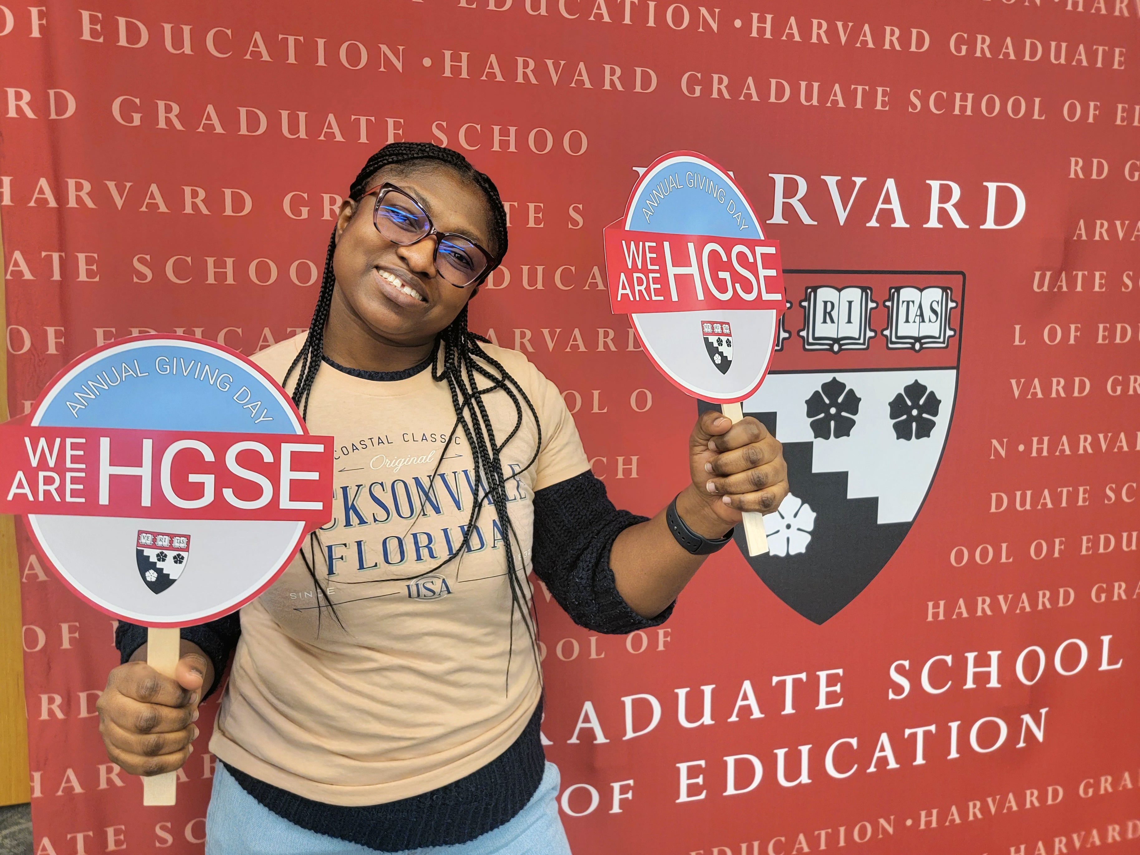 Student holding "we are HGSE sign"