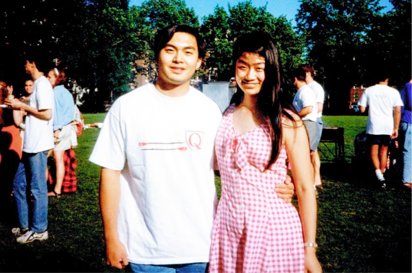 A photograph of Alfred and Rebecca Lin standing outdoors on campus during their time as students.