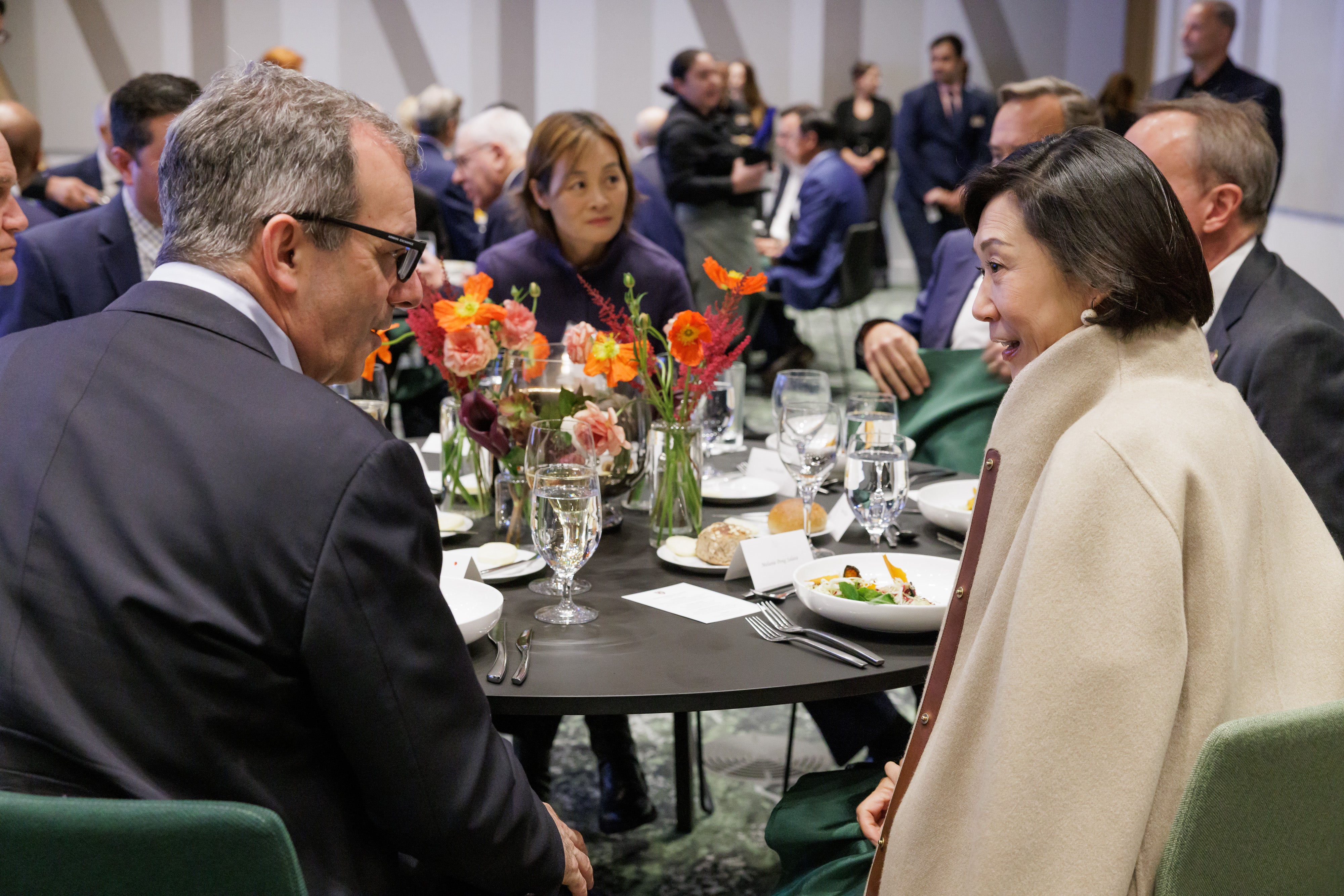 Provost John F. Manning and Melanie Pong Salata speak over dinner at the 2025 Global Advisory Council meeting.