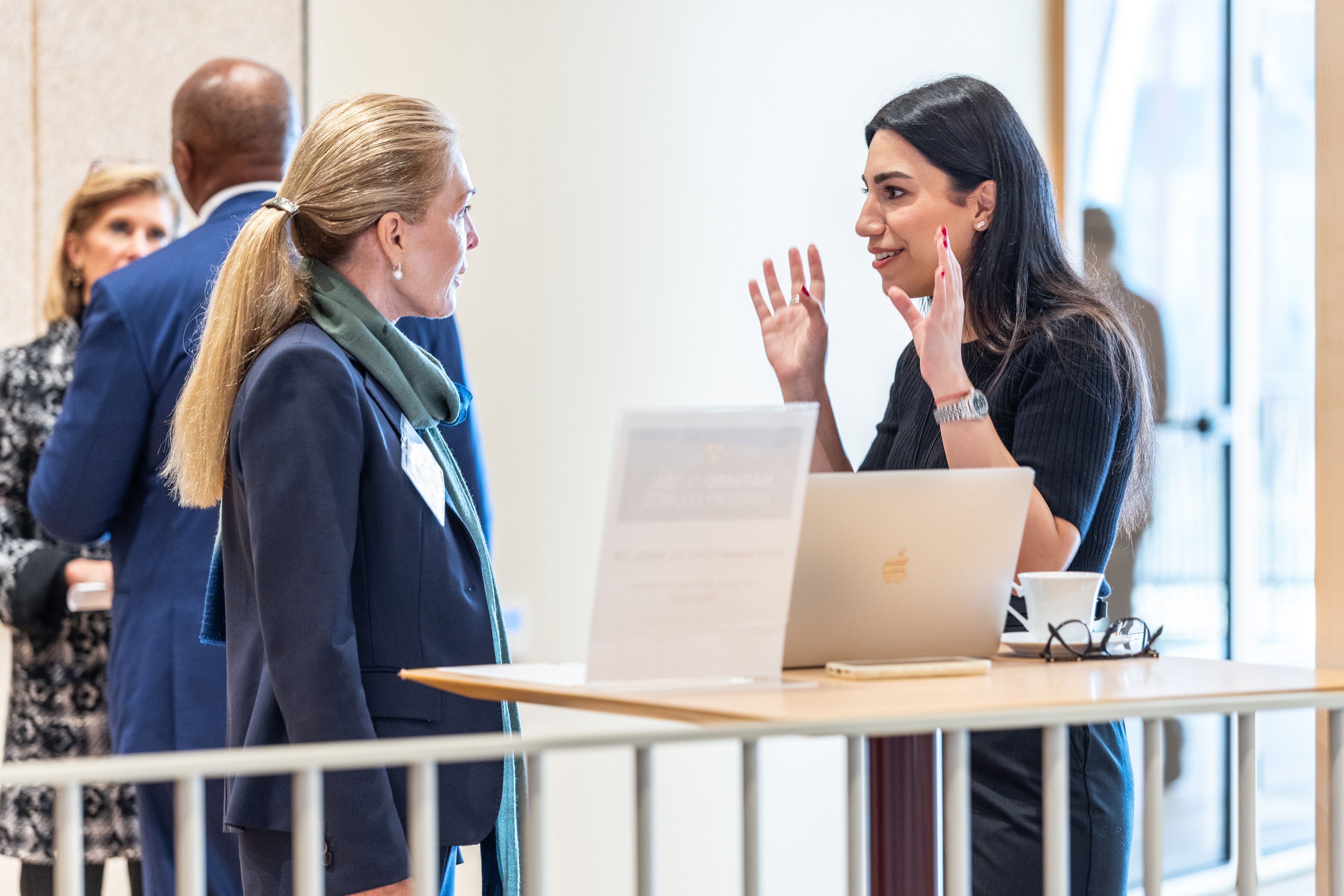 Brigitte Bren speaks with a Harvard student at the 2025 Global Advisory Council meeting.