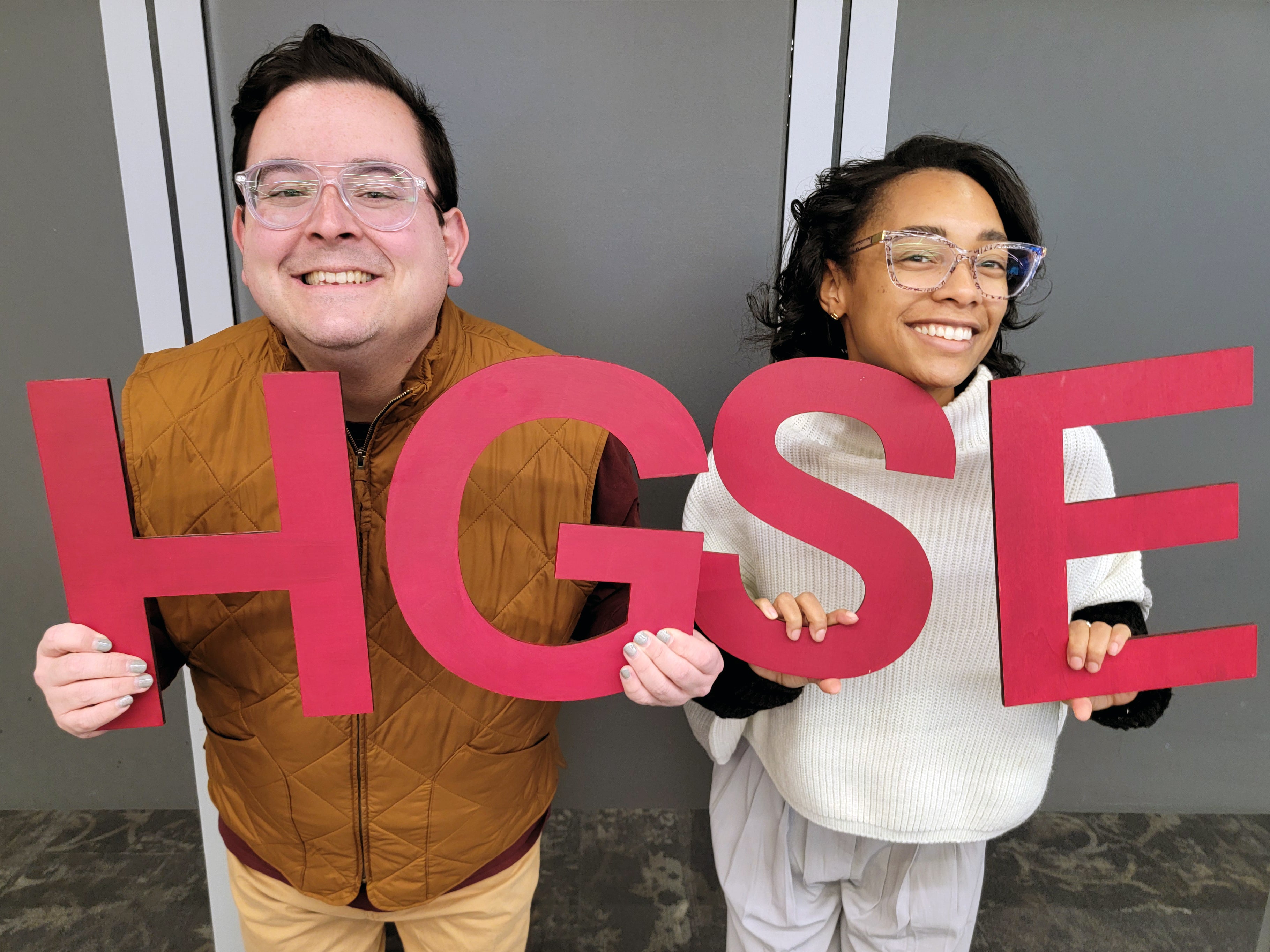 Students holding H G S E letters