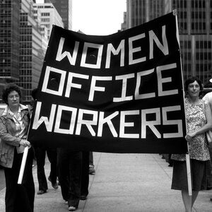 Protestors holding a sign that says "Women Office Workers"