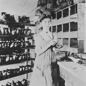 Woman working on repairing a shoe