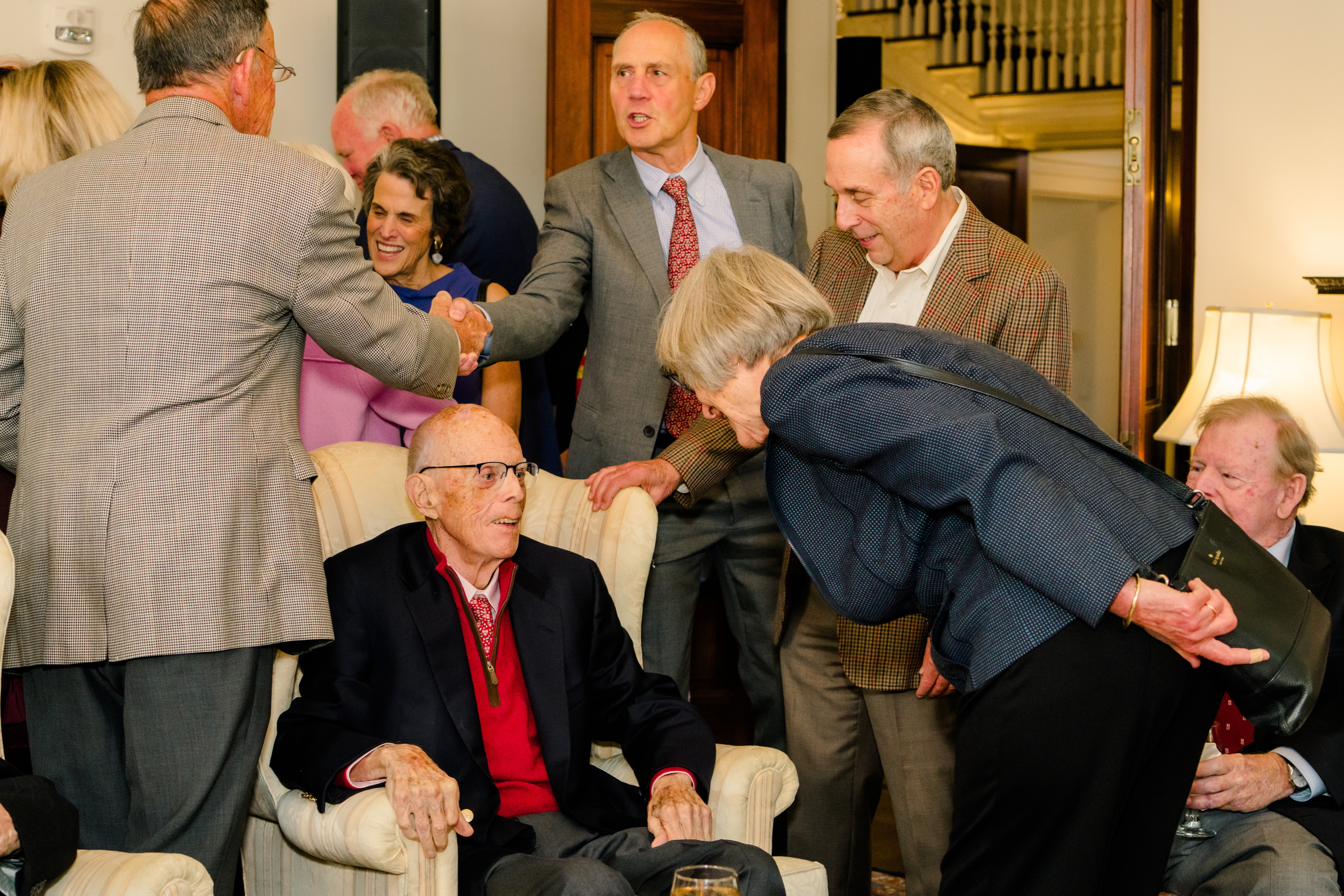Former Harvard presidents Drew Faust and Larry Bacow greeting Jack Reardon at his retirement celebration.