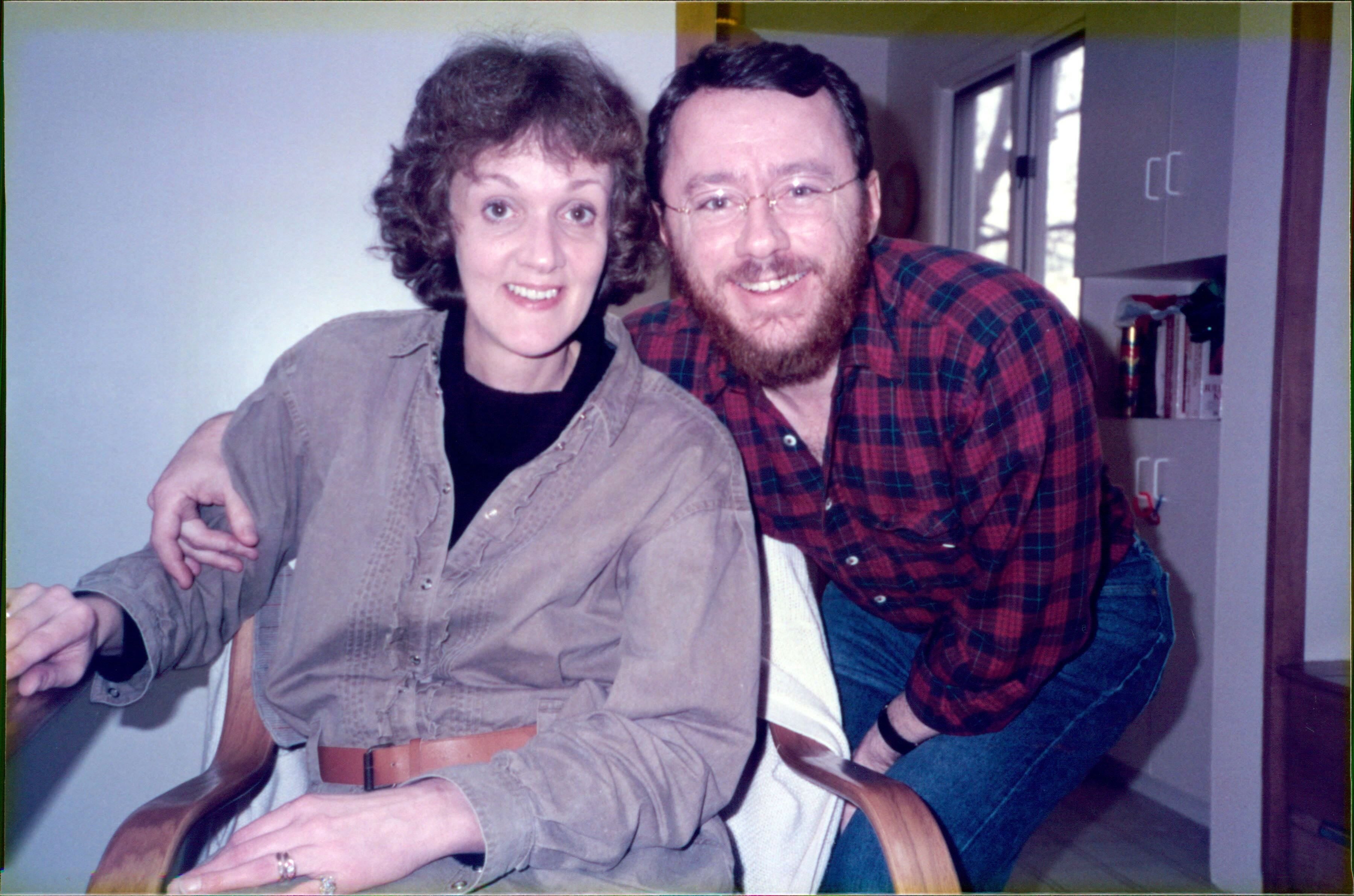 Tom (right) with his arm around his wife, Carole (left)