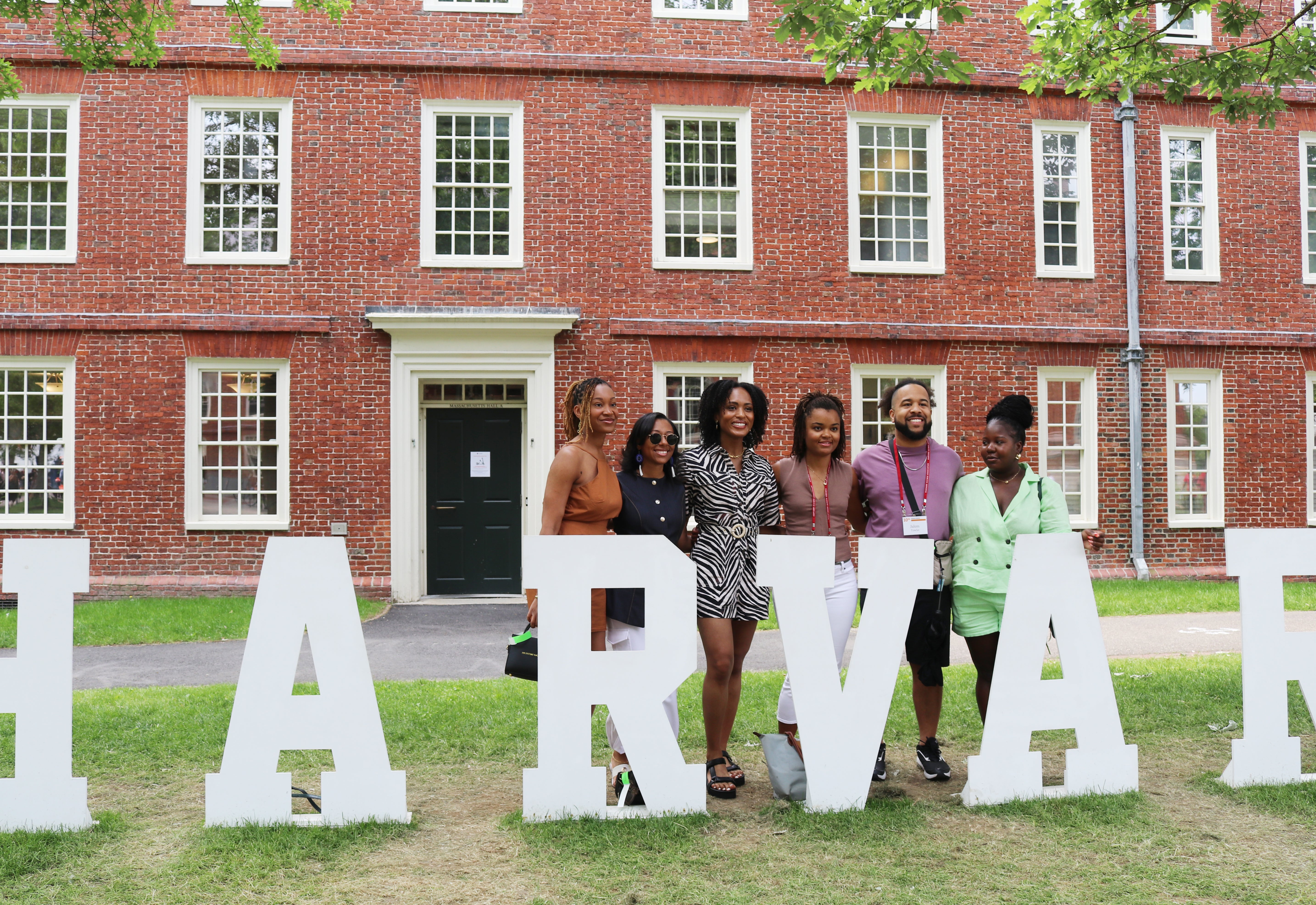 Group of alumni posing for a photo at Harvard Alumni Day.