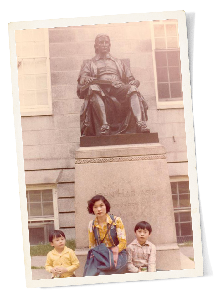 Edwin and Alfred Lin with their mother in front of the statue of John Harvard in Harvard Yard