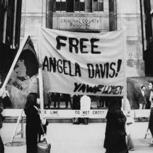 Protestors holding a sign that says "Free Angela Davis!"