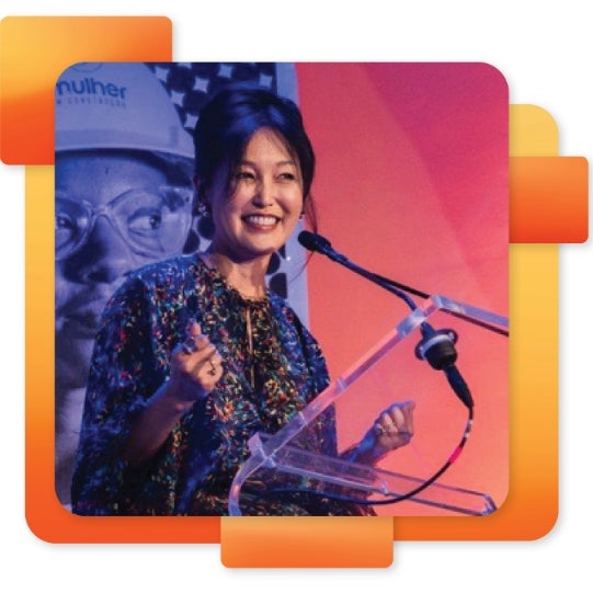 Heela Yang smiling behind a podium