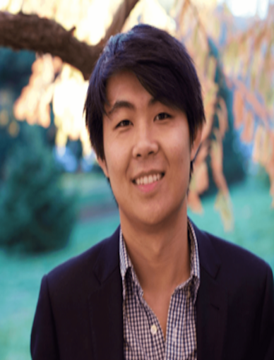 Asian man with black hair wearing a button-down shirt and black blazer