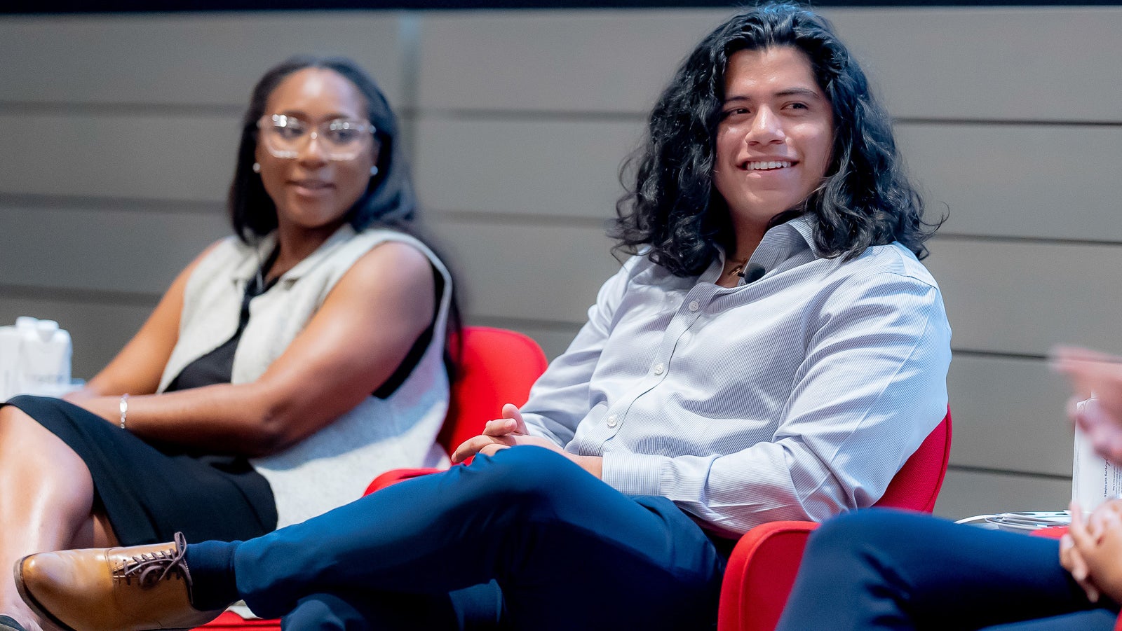 Sadé Abraham EdM ’18 and Andrew Pérez AB ’20 smile during the first-generation Harvard alumni panel