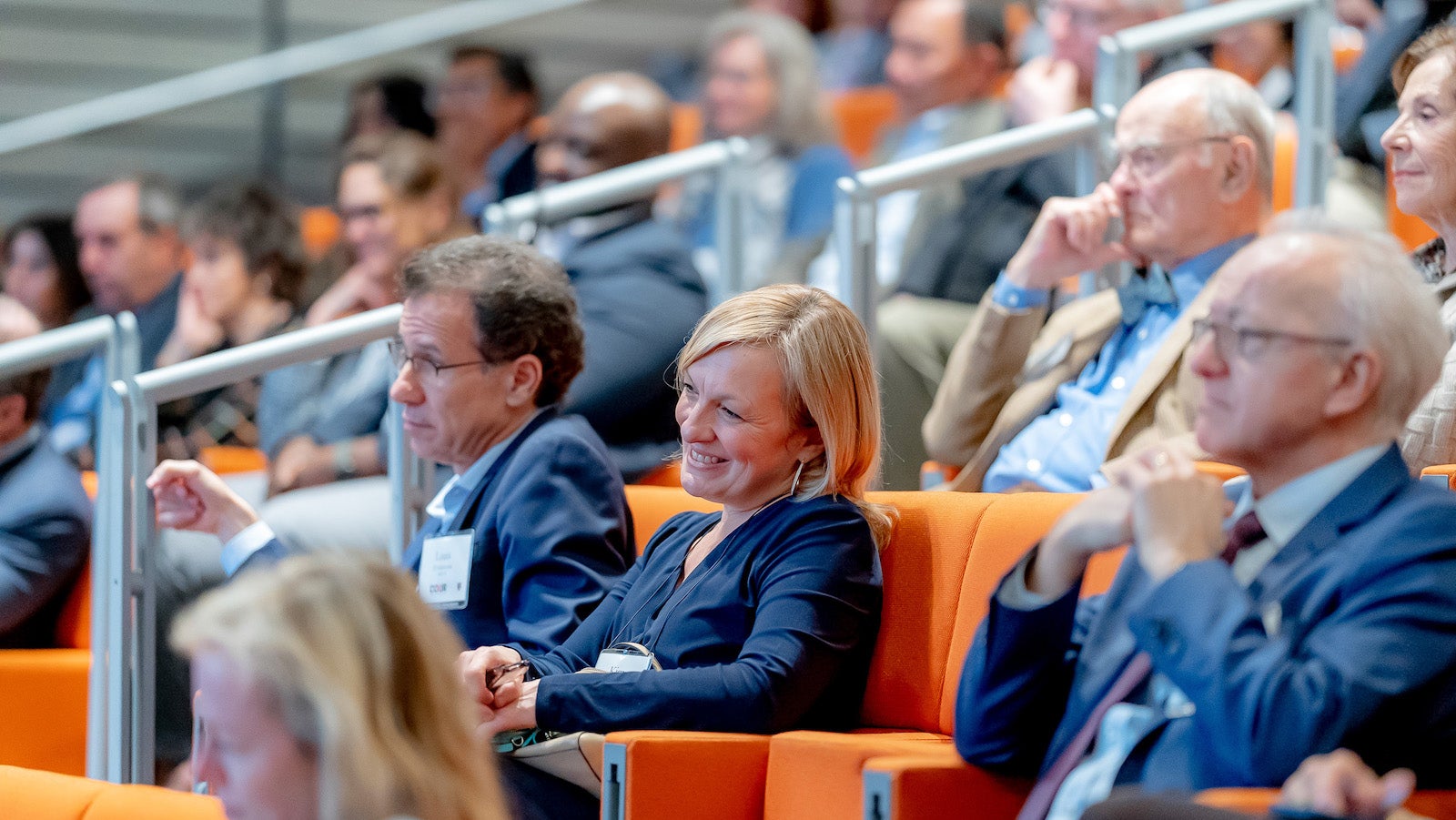 COUR member smiles listening to the panel with first-generation Harvard alumni