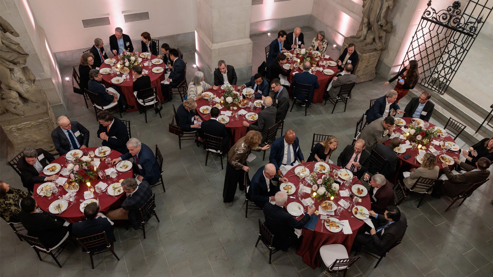 Overhead shot of guests gathering for dinner at the 2024 Global Advisory Council meeting.