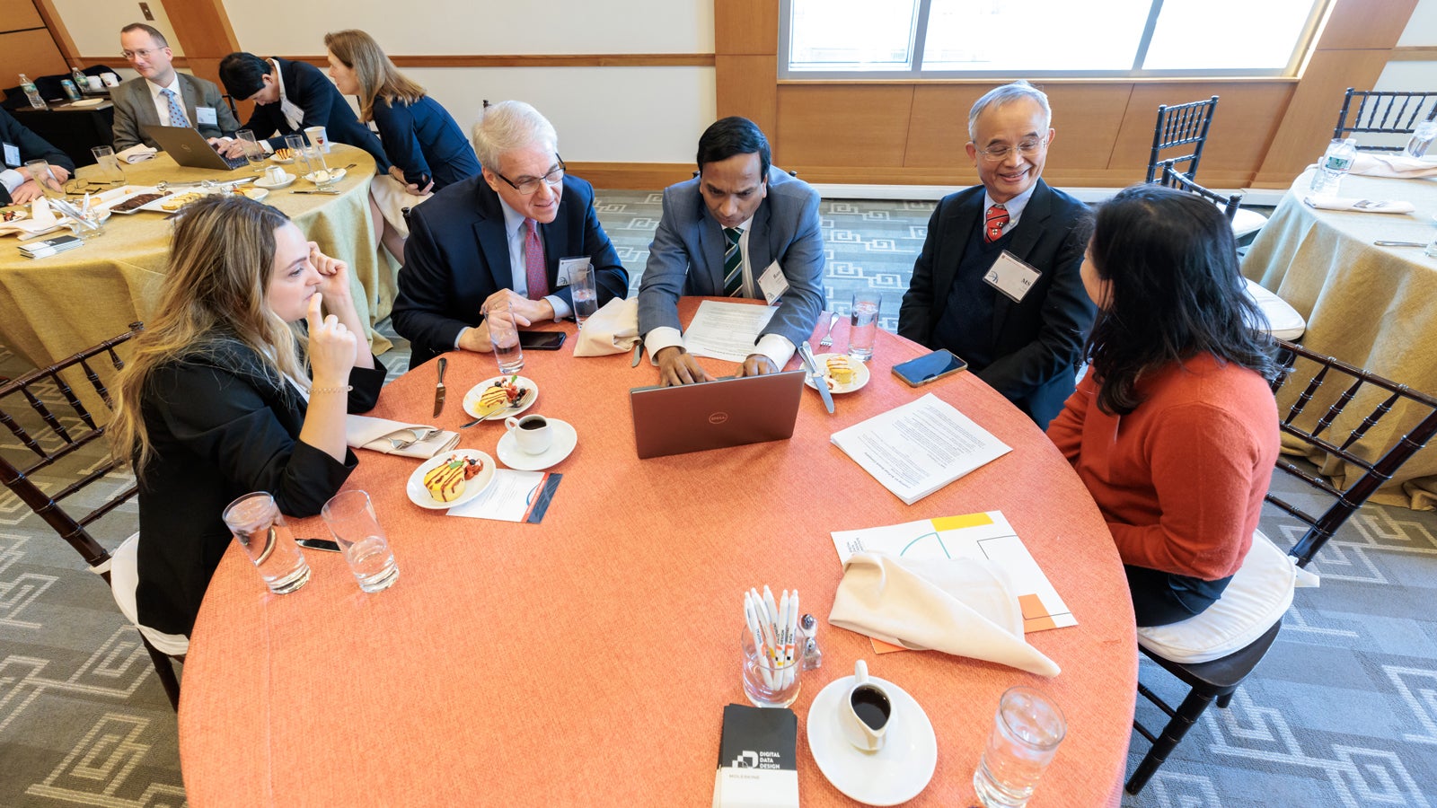 Brian Lee, Ramakrishna Sudireddy, and Mou-Shiung Lin, PhD ’82 joining Harvard staff in a creative exercise to develop their own AI-powered snack company at the 2024 Global Advisory Council meeting.