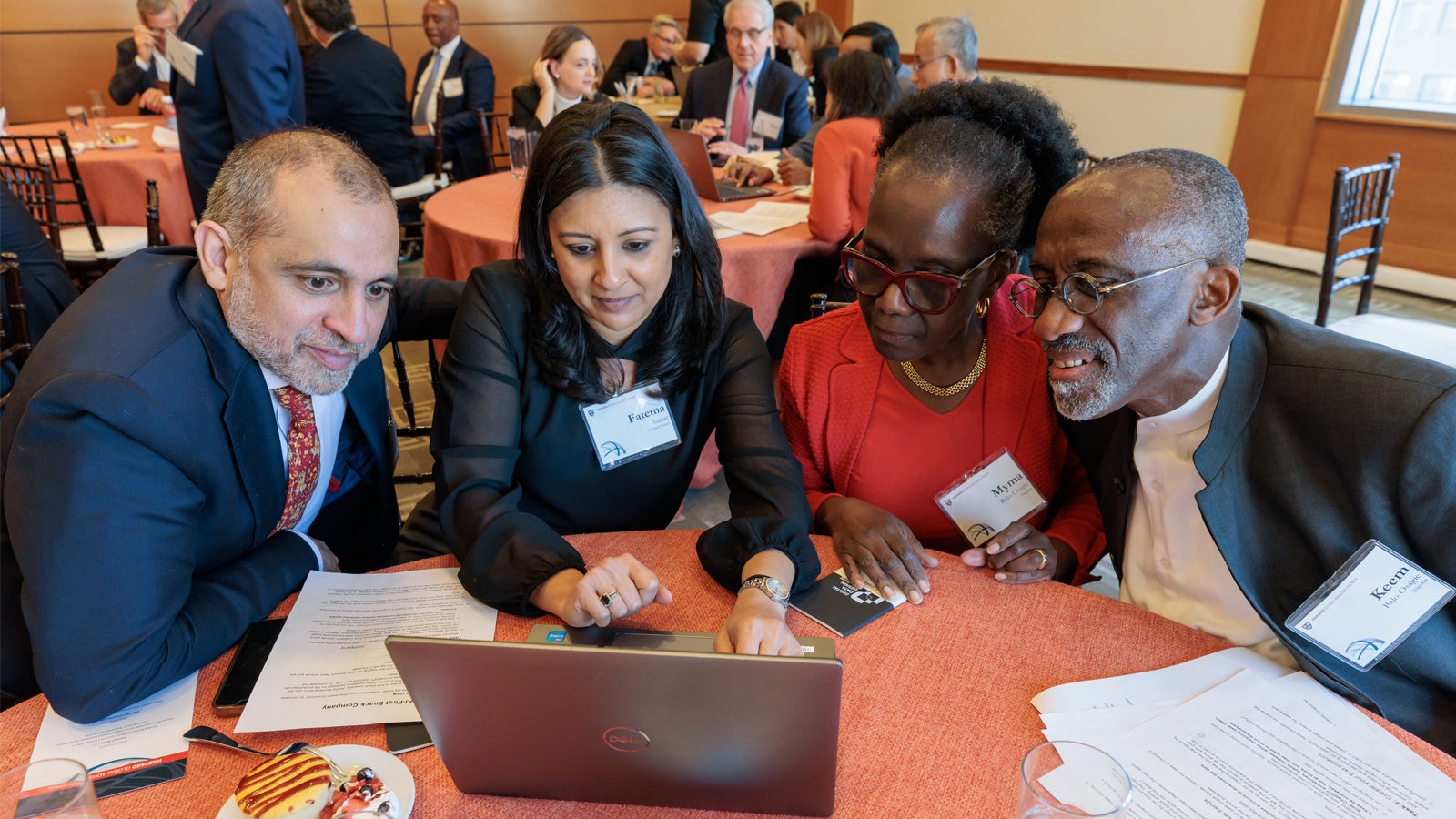 Asim I. Khwaja PhD ’01, Fatema Sumar, Myma Adwowa A. Belo-Osagie LLM ’78, SJD ’85, and Keem I. Belo-Osagie MBA ’80 participating in a creative exercise to develop their own AI-powered snack company at the 2024 Global Advisory Council meeting.