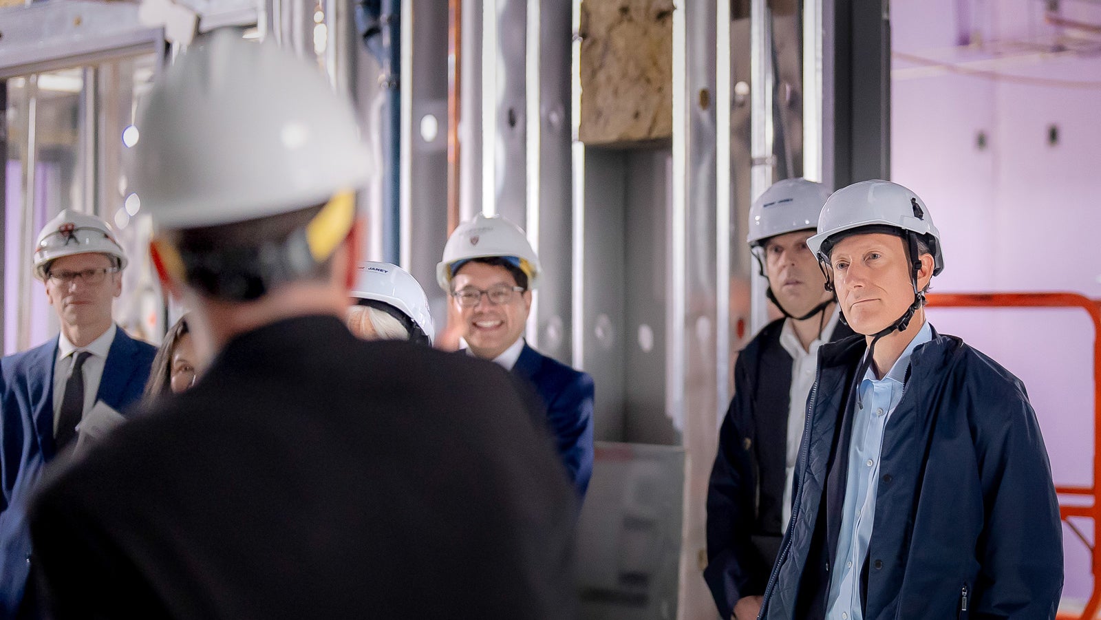 Several members of COUR participating in a hard hat tour of the future site of HQI at 60 Oxford Street