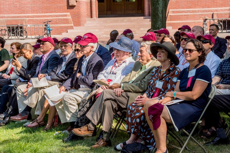 Alumni view the ceremony in front of Sever Hall. 