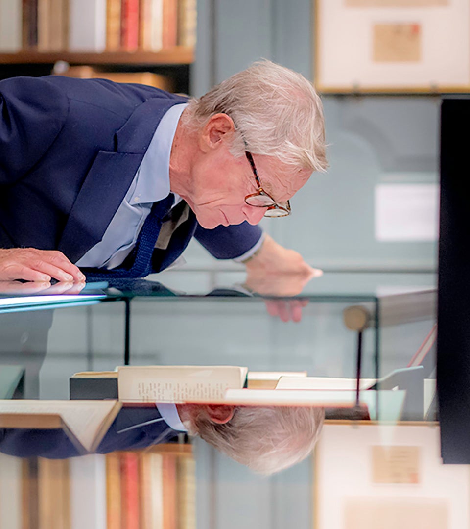 A guests examines one of the new exhibits in Houghton Library