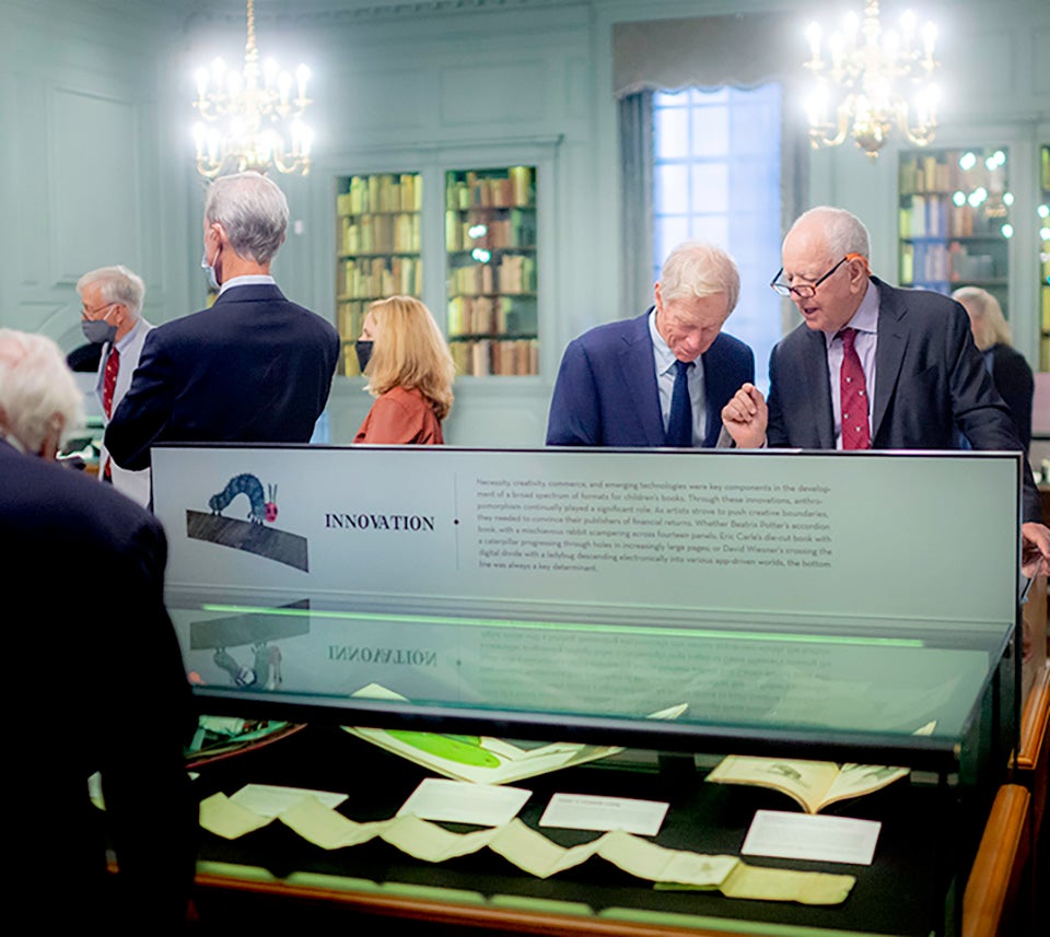 Guests examine the new exhibition in Houghton Library