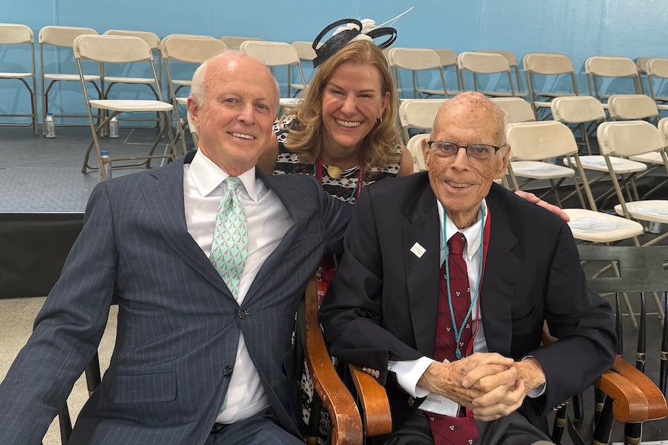 Paul Finnegan, Jack Reardon, and Kate Gellert on the stage at Commencement