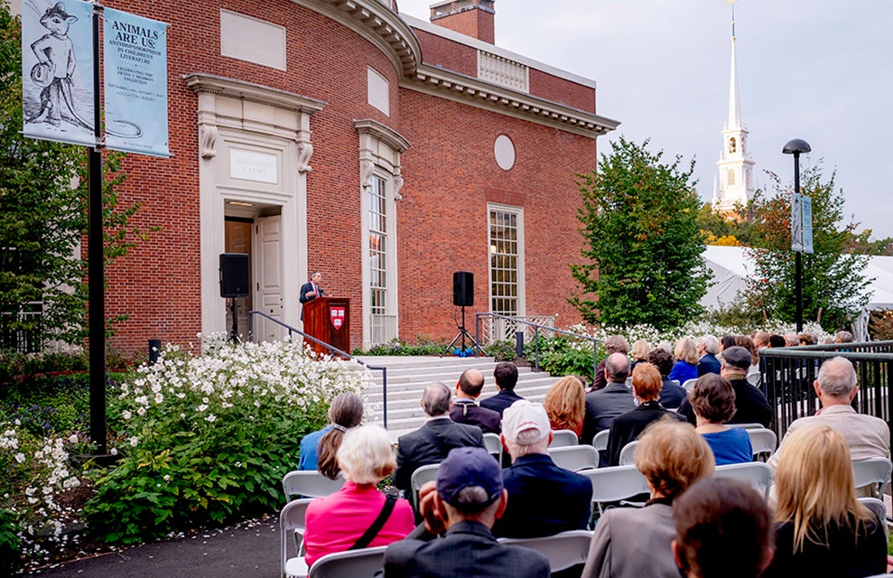 President Bacow addresses the crowd at the reopening of Houghton Library