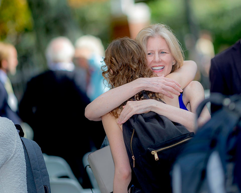 Guests embrace at the Houghton Library reopening