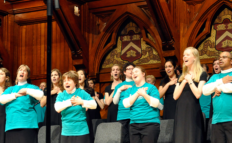 Choral singers from the Harvard-Radcliffe Collegium Musicum perform onstage at Sanders Theatre.