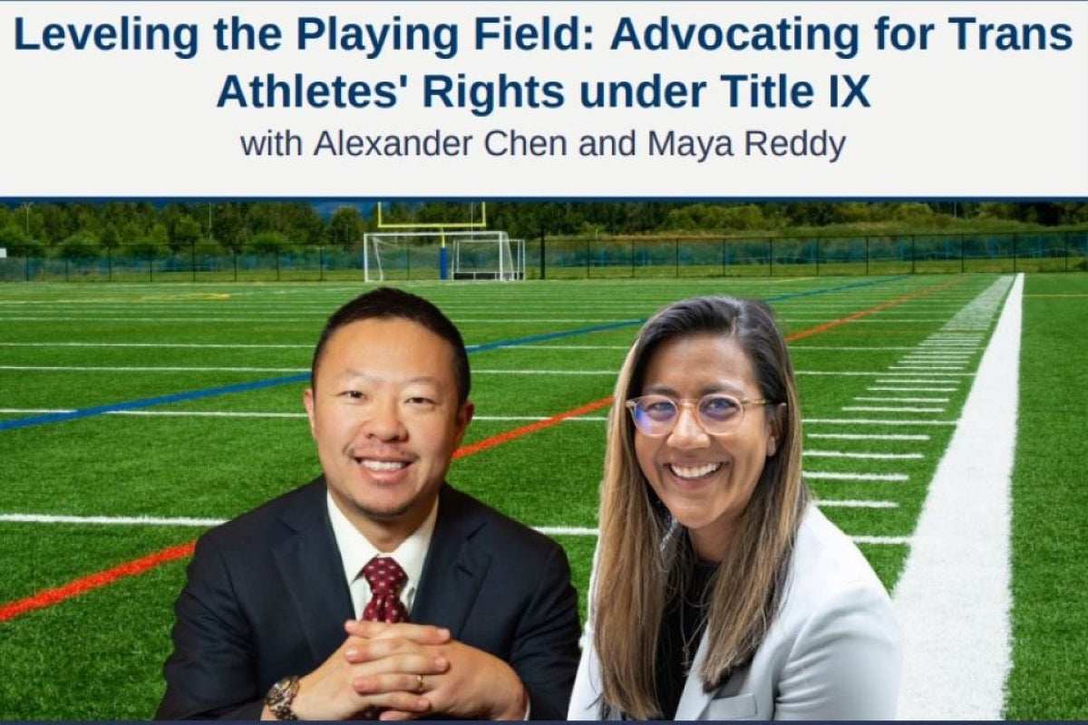 Alexander Chen and Maya Reddy smiling at camera in front of a football field 