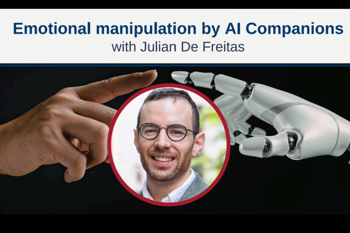 Headshot of Julian De Freitas with a human hand and robot hand nearly touching behind him
