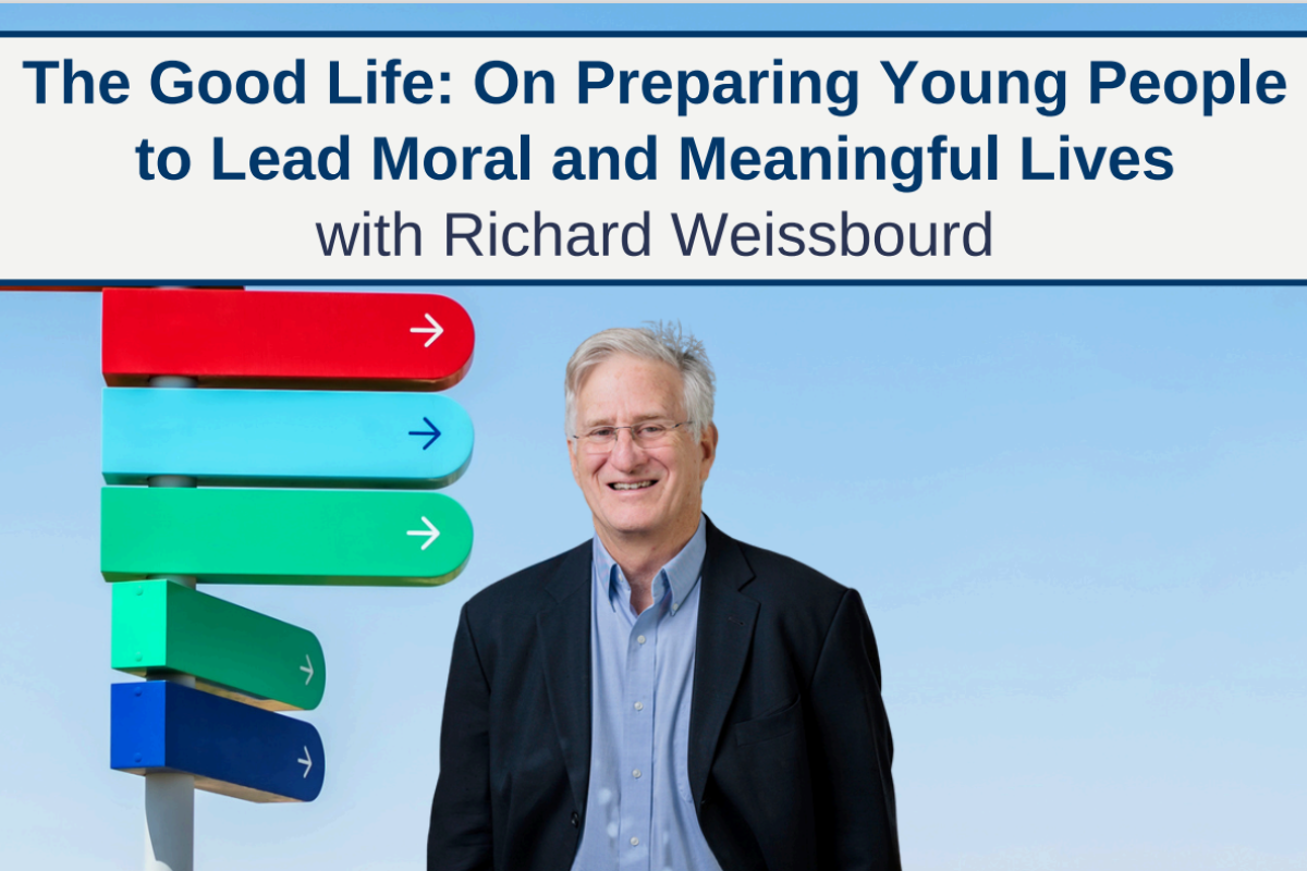 Richard Weissbourd smiling at camera in front of colorful signs pointing in different directions