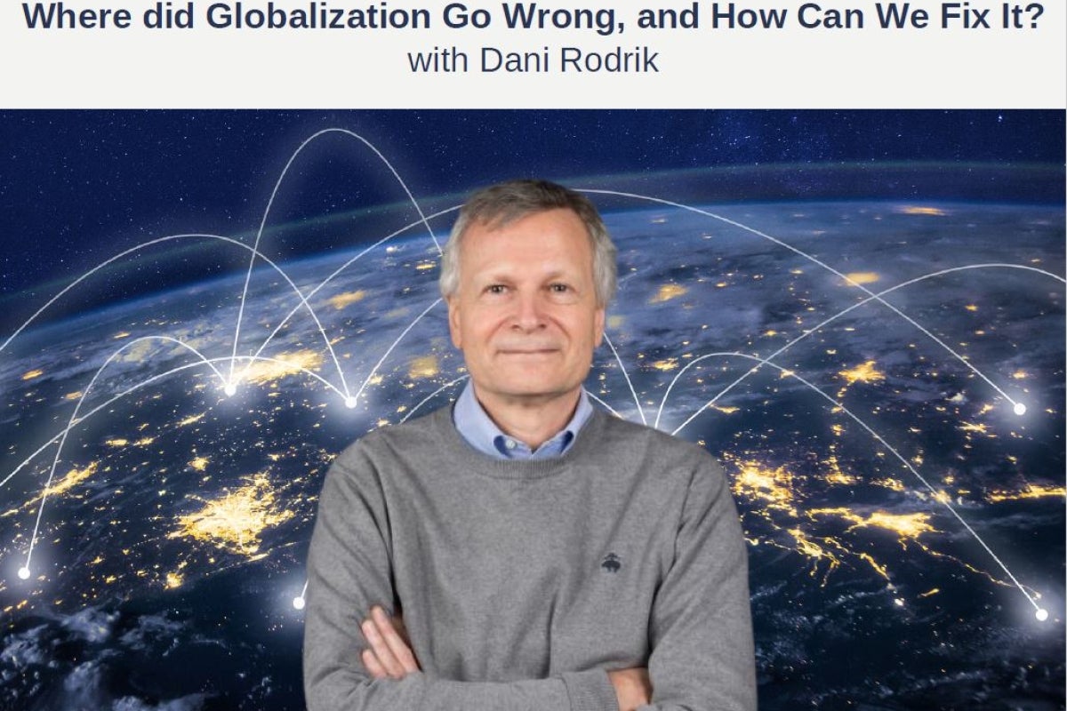 Dani Rodrik in front of a map with connections over the world