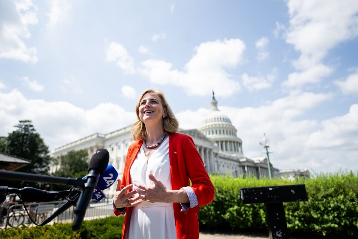 woman speaking at podium outsite