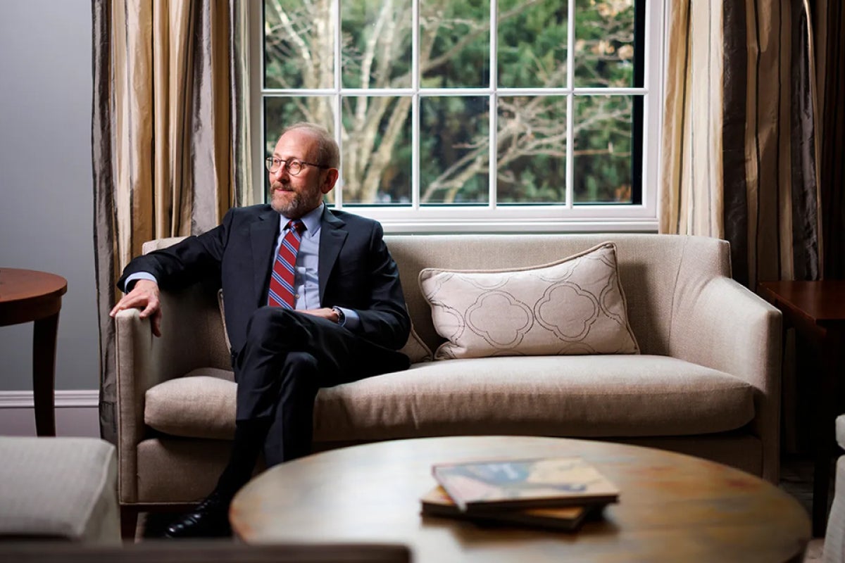 President Garber sits on his couch looking at the window