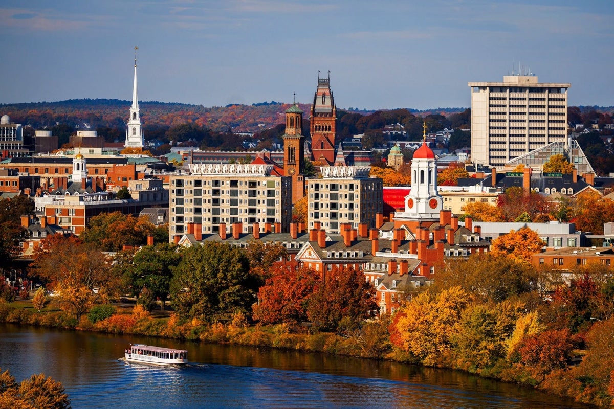 Aerial view of Cambridge depicting the Charles River, buildings and fall foliage