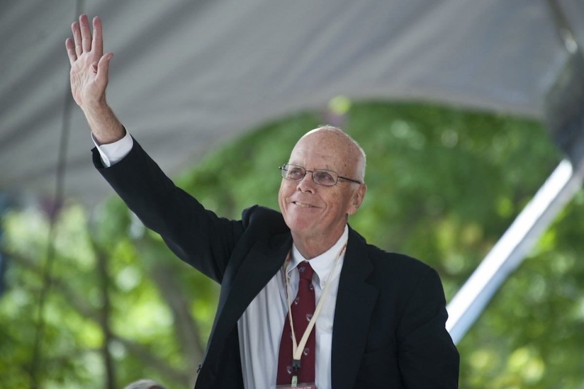 Jack Reardon smiles on stage in Harvard Yard