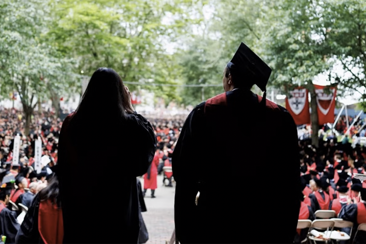 Silhouette of graduates overlooking Tercentenary Theatre on Commencement Day.