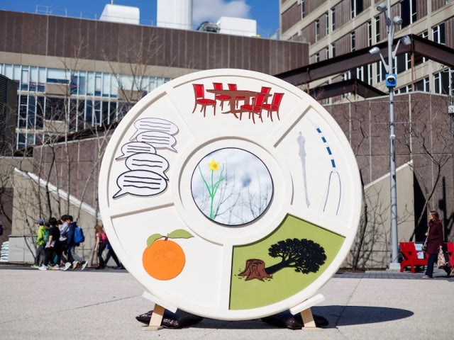 Giant Seder plate sculpture on Harvard's campus with colorful custom images