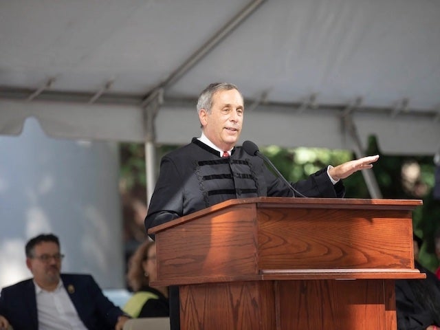 President Larry Bacow gives his Convocation address at the lectern in Tercentenary Theatre.