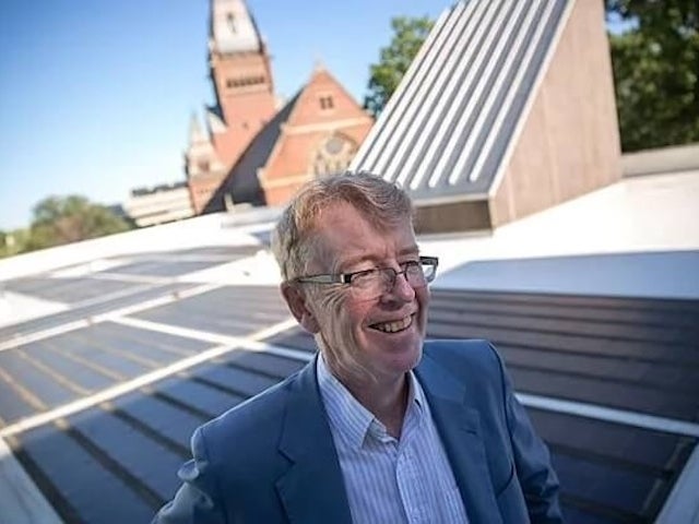 Michael McElroy with solar panels in the background