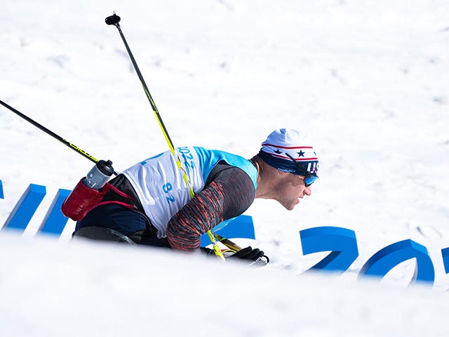 Dan Cnossen skiing with snow in the foreground and background