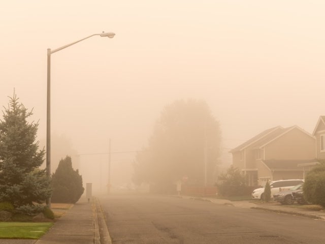A suburban street hazy with wildfire smoke