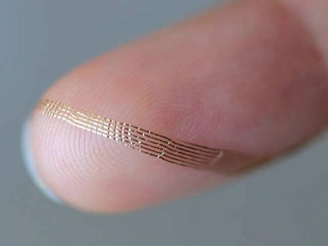 Close-up of flexible brain implant on a finger