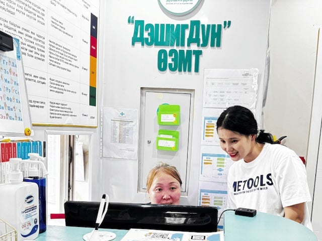  Two women working at a computer in a medical office in Mongolia