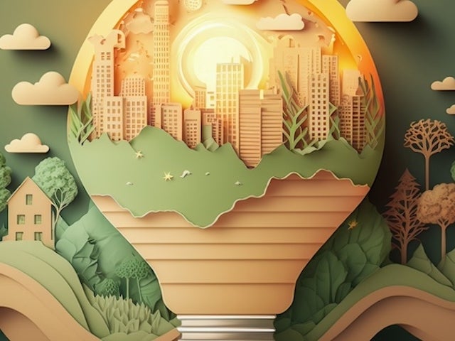 Green and tan graphic of a lightbulb that contains a cityscape within